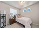 Cozy bedroom featuring a bed with white linens, a nightstand, and a modern floor lamp at 22072 E 38Th Pl, Aurora, CO 80019