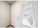 Bright entryway featuring a white door, neutral walls, and a window providing natural light at 22072 E 38Th Pl, Aurora, CO 80019