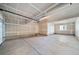 Spacious unfinished two-car garage with high ceilings and visible door mechanics at 22072 E 38Th Pl, Aurora, CO 80019