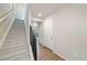 Hallway featuring wood floors, a staircase, and doors leading to other rooms in the home at 22072 E 38Th Pl, Aurora, CO 80019