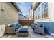 Inviting back patio with ample seating for entertaining, lit by string lights at 5735 Boston St, Denver, CO 80238