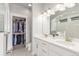 Bright bathroom with a double vanity, undermount sinks, and walk-in closet for ample storage space at 5735 Boston St, Denver, CO 80238