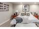 Modern bedroom with coordinated bedside tables, sleek lamps, and tasteful wall art for an elegant touch at 5735 Boston St, Denver, CO 80238
