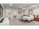 Bedroom with a calming color palette, featuring stylish furnishings, and access to ensuite bath at 5735 Boston St, Denver, CO 80238