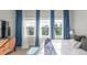 Sun-filled bedroom with big windows, designer curtains, and chic decor elements at 5735 Boston St, Denver, CO 80238