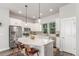 Stylish kitchen features white cabinets, granite countertops, stainless appliances, and sleek pendant lighting at 5735 Boston St, Denver, CO 80238