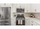 Modern kitchen with stainless steel appliances, granite countertops, and ample cabinet space at 5735 Boston St, Denver, CO 80238