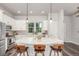 Well-lit kitchen with a large island, stainless steel appliances, and modern pendant lighting at 5735 Boston St, Denver, CO 80238
