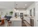 Bright, modern kitchen with white cabinets, stainless steel appliances, and a large center island at 5735 Boston St, Denver, CO 80238