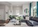 Comfortable living room featuring a plush sectional sofa and sophisticated decor at 5735 Boston St, Denver, CO 80238