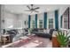 Bright living room with oversized couch, large windows, and accent rug at 5735 Boston St, Denver, CO 80238