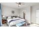 Cozy bedroom with ensuite bath, accent seating, and modern lighting fixtures at 5735 Boston St, Denver, CO 80238