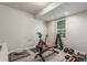 Well-lit workout room with exercise equipment including weights, bench, and stationary bike at 5735 Boston St, Denver, CO 80238