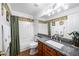 Bathroom featuring a vanity with granite countertop, tile backsplash and a shower with bathtub combo at 1387 Mcintosh Ave, Broomfield, CO 80020