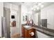 Bathroom featuring vanity with granite top, mirrors, and neutral color palette at 1387 Mcintosh Ave, Broomfield, CO 80020