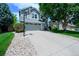Suburban home showcasing a driveway with a basketball hoop, gray exterior and manicured landscaping at 1387 Mcintosh Ave, Broomfield, CO 80020