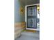 Close-up of a charming front porch featuring a decorative screen door, brick accents, and welcome mat at 1387 Mcintosh Ave, Broomfield, CO 80020