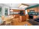 Bright kitchen with dark granite countertops, cherry cabinets, a center island, and natural light from a window at 1387 Mcintosh Ave, Broomfield, CO 80020