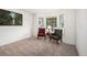 Bright living room showcasing a bay window, plush carpet, and elegant seating arrangement at 1387 Mcintosh Ave, Broomfield, CO 80020
