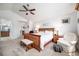 Bright primary bedroom with a wooden bed frame and chair at 1387 Mcintosh Ave, Broomfield, CO 80020