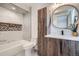 Contemporary bathroom featuring a modern vanity, stylish mirror, and tiled backsplash at 2599 S Cherokee St, Denver, CO 80223