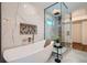 Luxurious bathroom featuring a freestanding tub and separate glass-enclosed shower at 2599 S Cherokee St, Denver, CO 80223