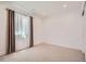 Bright, carpeted bedroom with a large window and sheer curtains, offering soft, natural light at 2599 S Cherokee St, Denver, CO 80223