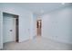 Bright bedroom with a closet, white walls and neutral carpet, offering a clean aesthetic at 2599 S Cherokee St, Denver, CO 80223