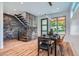 Elegant dining area featuring a unique staircase design, stylish decor, and plenty of natural light at 2599 S Cherokee St, Denver, CO 80223
