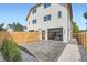Back yard and patio with stained wood fence and stylish roll-up glass door at 2599 S Cherokee St, Denver, CO 80223