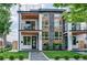 Modern two-story home with stone accents, balcony, and landscaped front yard at 2599 S Cherokee St, Denver, CO 80223