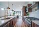 Modern open kitchen with stainless appliances, marble backsplash, quartz island and garage door to outside patio at 2599 S Cherokee St, Denver, CO 80223