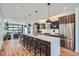 Spacious kitchen features a large island with seating, stainless steel appliances, and hardwood floors at 2599 S Cherokee St, Denver, CO 80223