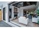 Inviting living room with open garage door, a fireplace, and seamlessly connects indoor and outdoor living spaces at 2599 S Cherokee St, Denver, CO 80223