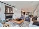 Open-concept living room featuring a cozy fireplace, modern decor, and an inviting atmosphere at 2599 S Cherokee St, Denver, CO 80223