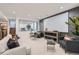 Spacious living room with plush seating, stylish decor, and a large white projector screen at 2599 S Cherokee St, Denver, CO 80223
