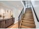 Inviting staircase featuring wood treads, iron railings, and stylish decor at 2599 S Cherokee St, Denver, CO 80223