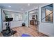 Modern workout room with sleek wood floors, a mirror and access to a stylish bar area at 2599 S Cherokee St, Denver, CO 80223