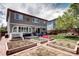 Charming backyard features garden beds, a brick patio, a lush lawn, and ample space for relaxation and entertaining at 4907 Fenwood Dr, Highlands Ranch, CO 80130