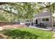 Inviting backyard with patio, lush lawn, garden beds, perfect for outdoor living and entertaining at 4907 Fenwood Dr, Highlands Ranch, CO 80130