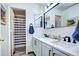 Bright bathroom with double vanity, white countertop, and a shower behind door at 4907 Fenwood Dr, Highlands Ranch, CO 80130
