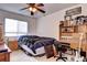 Functional bedroom with a bed, desk, shelving, and natural light at 4907 Fenwood Dr, Highlands Ranch, CO 80130