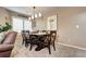 Well-lit dining area with a dark wood table, comfortable seating, and stylish light fixture at 4907 Fenwood Dr, Highlands Ranch, CO 80130