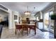 Well-lit dining room features a rustic wooden table and access to an outdoor patio at 4907 Fenwood Dr, Highlands Ranch, CO 80130
