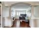 Bright home office space featuring an archway entrance and hardwood floors at 4907 Fenwood Dr, Highlands Ranch, CO 80130