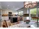 Bright kitchen featuring custom cabinets, granite countertops, and modern appliances at 4907 Fenwood Dr, Highlands Ranch, CO 80130