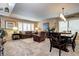 Bright living room features cozy seating, carpeted floors, and an adjacent dining area for easy entertaining at 4907 Fenwood Dr, Highlands Ranch, CO 80130