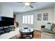 Comfortable living room with plush sofa and large window letting in ample natural light at 4907 Fenwood Dr, Highlands Ranch, CO 80130