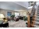 Inviting living area showcases plush seating and elegant decor adjacent to a dining space with ample natural light at 4907 Fenwood Dr, Highlands Ranch, CO 80130