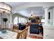 Inviting living space features arched entryway, hardwood floors, built-in shelving, and comfortable seating at 4907 Fenwood Dr, Highlands Ranch, CO 80130